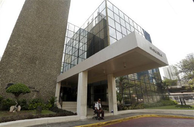 A security guard sits outside the Mossack Fonseca law firm Sunday in Panama City. Photo: Arnulfo Franco / Associated Press