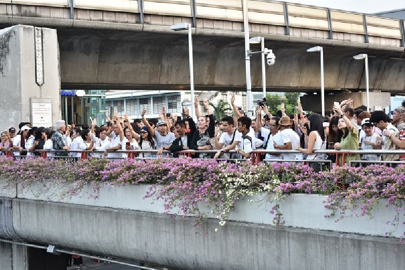 Protesters raised three fingers in the ‘Hunger Games’-inspired salute which has been adopted as a symbol of protest against the junta Tuesday evening at Victory Monument in Bangkok.