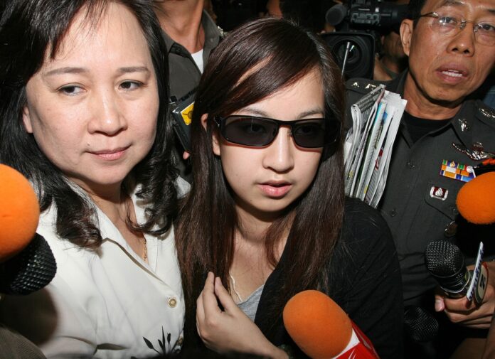 Orachorn ‘Praewa’ Thephasadin Na Ayudhya turns herself in at Metropolitan Police Bureau headquarters Jan. 5, 2011, in Bangkok.