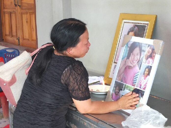 Families of the children killed earlier this month in a school dormitory fire perform funeral rites according to their beliefs Tuesday in Chiang Rai province.