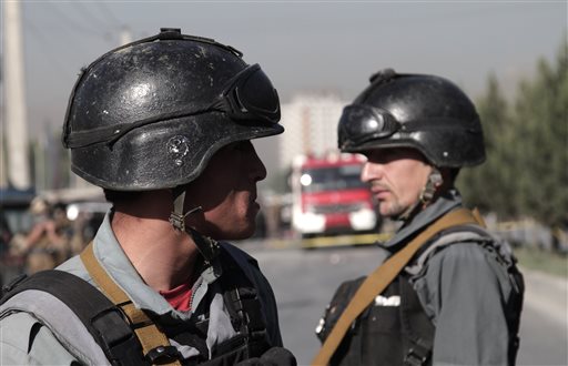 Afghan police soldiers inspect the site of a suicide attack in Kabul earlier on June 20. At least a dozen Nepalese security guards of a foreign logistic company were killed. Photo: Rahmat Gul / Associated Press