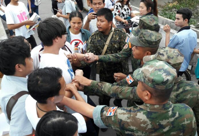 Security officers arrest activist Rangsiman Rome Thursday in the Bang Phli district of Samut Prakan province.