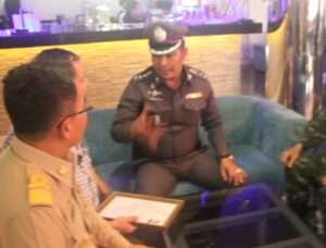 Apichai talks to the owner of one of the massage parlors in Pattaya on Wednesday.