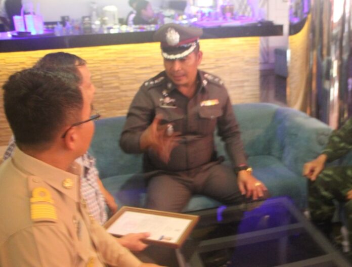 Apichai talks to the owner of one of the massage parlors in Pattaya on Wednesday.