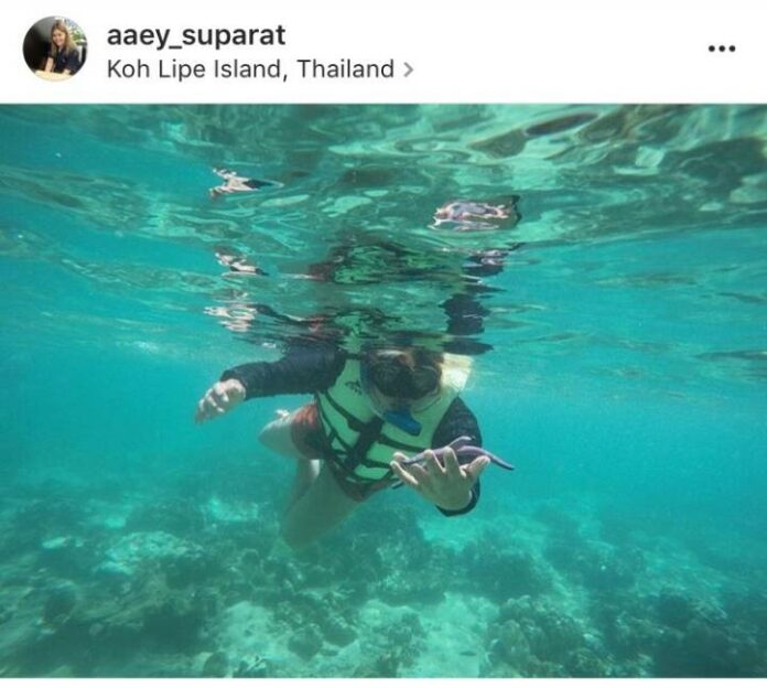 A snorkeler poses with a starfish in an image posted June 12 to a now-deactivated Instagram account.