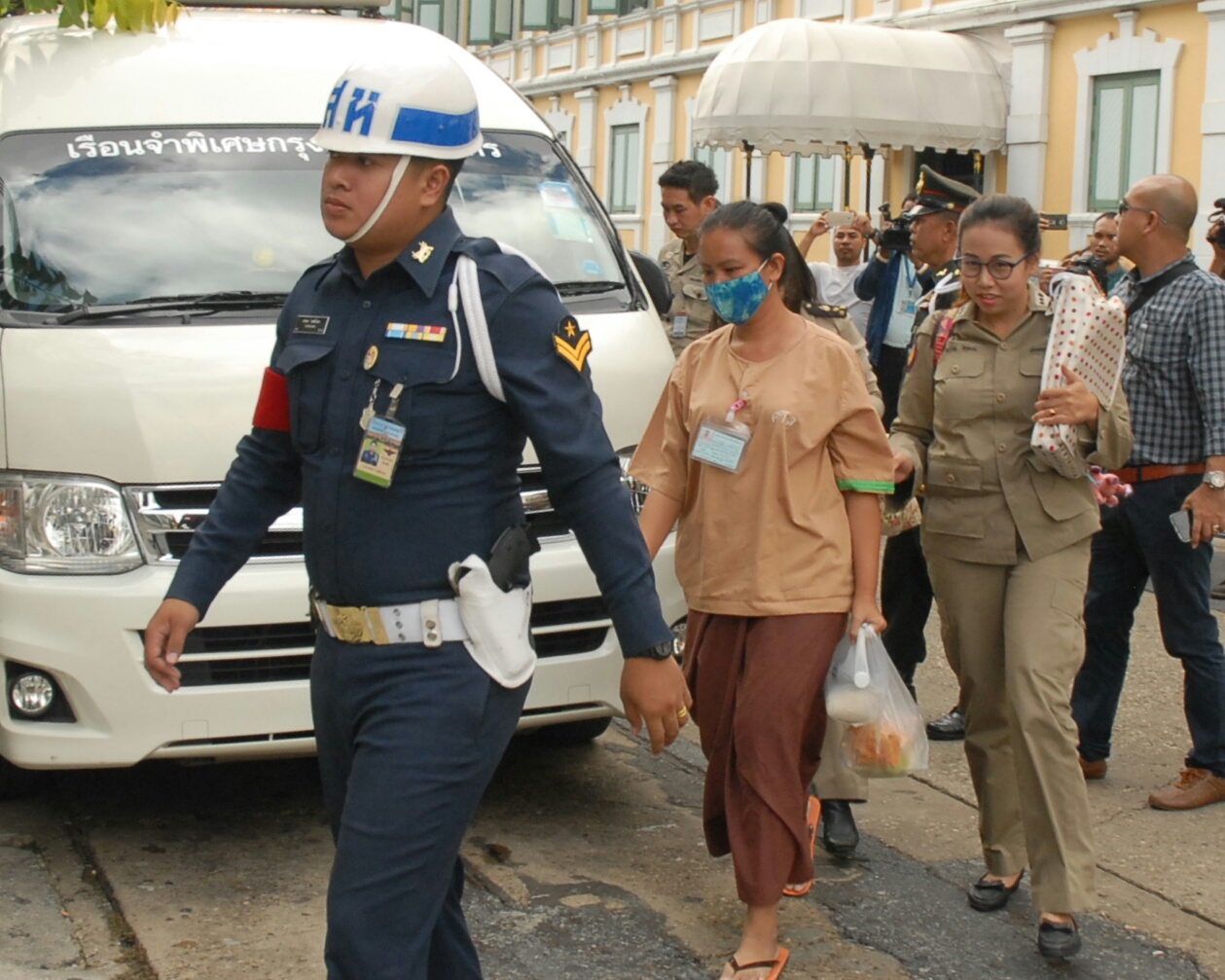 Security officers bring Nuttigar Woratunyawit to the military court on Wednesday to hear her bail ruling.