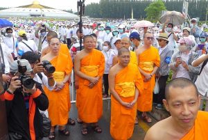 Dhammakaya monks await the arrival of law enforcement Thursday at their temple complex north of Bangkok.