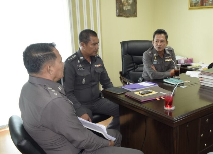 Police officers discuss the investigation with the victim, not pictured, June 23 at the Pattaya Police Station in Chonburi province.