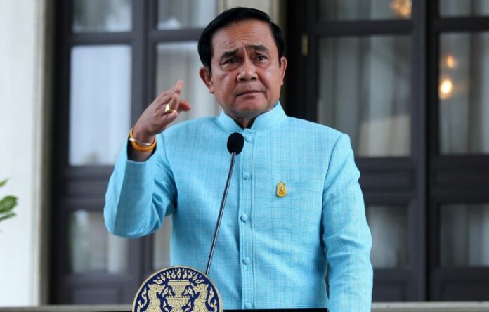 Junta chairman Prayuth Chan-ocha speaks to reporters in 2016 at Government House in Bangkok.