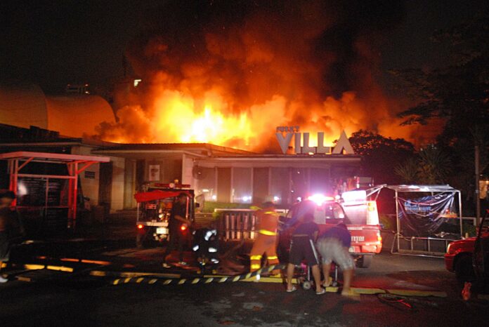 Firefighters battle the flames at Funky Villa early Tuesday morning in Bangkok.