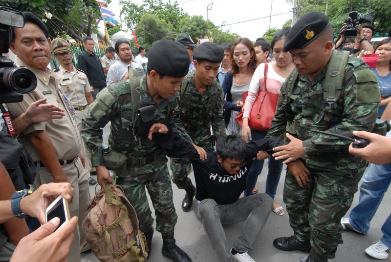 Soldiers break up a small rally by activists seeking to show solidarity with the seven jailed referendum campaigners last July in front of the Bangkok Remand Prison.