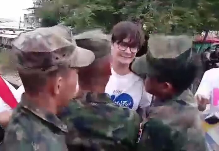 Soldiers surround activist Rome Rangsiman moments before they forcefully drag him away Thursday evening in eastern Bangkok.
