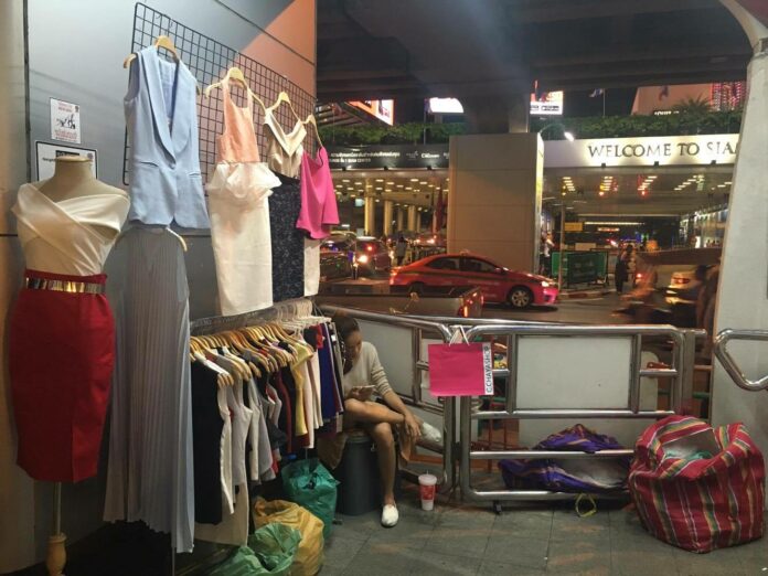 A street stall selling fashion apparel at the end of the stairs leading up to BTS Siam.