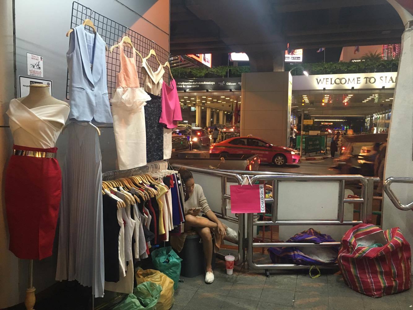A street stall selling fashion apparel at the end of the stairs leading up to BTS Siam.
