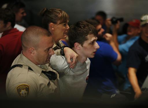 In this June 18, 2016, file photo, police remove protester Michael Steven Sandford as Republican presidential candidate Donald Trump speaks at the Treasure Island hotel and casino in Las Vegas. Photo: John Locher / Associated Press