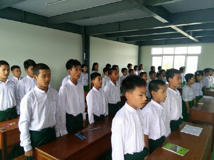Students at a Yangon school founded by nationalist Buddhist monks began their class by singing Myanmar's national anthem on Wednesday. Photo: Mahaw Thadar High School