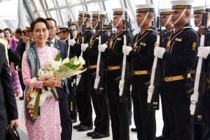 Arriving to Thailand for the first time as a de facto head of state, Aung San Suu Kyi was received by an honor guard Thursday at Bangkok's Suvarnabhumi Airport.