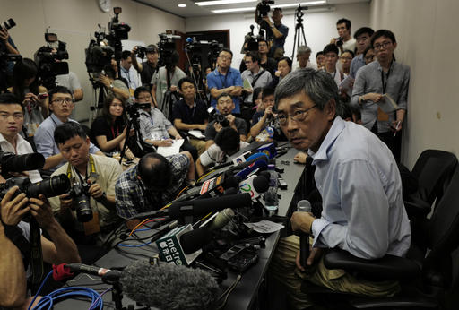 Freed Hong Kong bookseller Lam Wing-kee, right, listens to reporter's questions during a news conference in Hong Kong Thursday, June 16, 2016. Photo: Vincent Yu / Associated Press