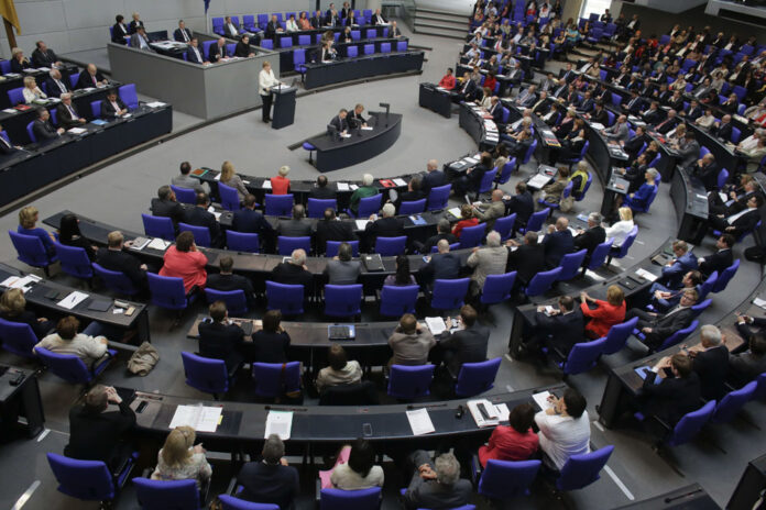 German Chancellor Angela Merkel, at podium, addresses the German parliament Bundestag with a so-called Government Declaration about the British vote to leave the EU, Tuesday in Berlin. Photo:Markus Schreiber / Associated Press