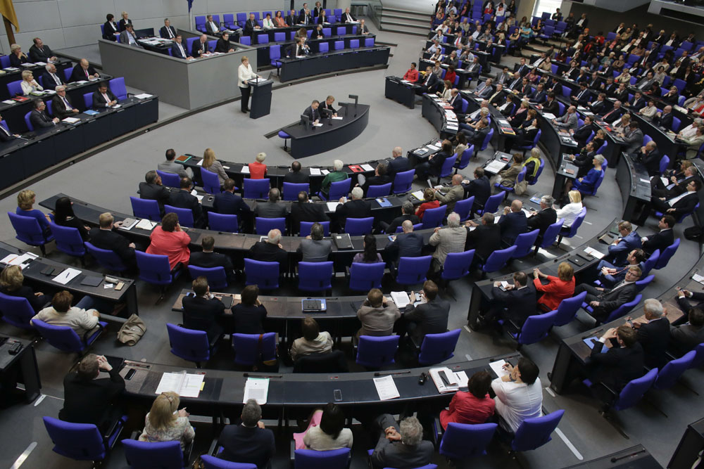 German Chancellor Angela Merkel, at podium, addresses the German parliament Bundestag with a so-called Government Declaration about the British vote to leave the EU, Tuesday in Berlin. Photo:Markus Schreiber / Associated Press