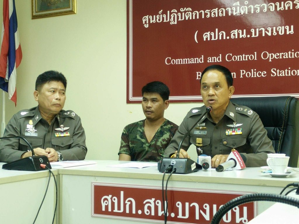 Winai Saeng-ngam, center, sits at police news conference Tuesday announcing his arrest in Bangkok.