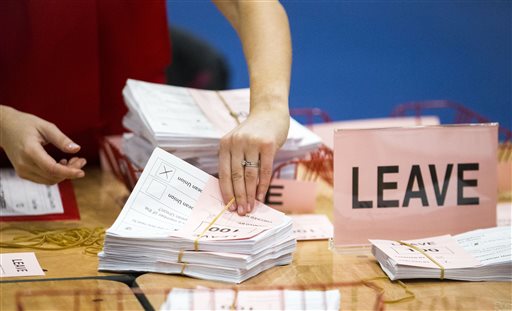 A teller counts ballot papers at the Titanic Exhibition Centre in Belfast, Northern Ireland, after polls closed in the EU referendum Thursday, June 23, 2016. Photo: Liam McBurney / PA / Associated Press