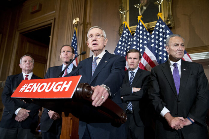 From left, Democratic Party Senator Richard Durbin of Illinois listens to US Senate minority leader Harry Reid of Navada along with senators Richard Blumenthal of Connecticut, Chris Murphy of Connecticut and Charles Schumer of New York. Photo: Alex Brandon / Associated Press