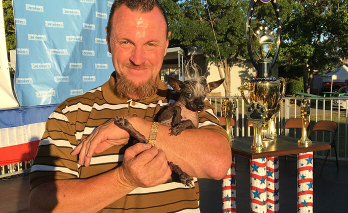 Sweepee Rambo is held by owner Jason Worz. Photo: Karen Spencer / World's Ugliest Dog Contest