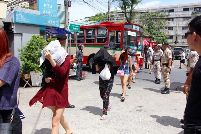 Sex workers rescued from Nataree Entertainment were brought to Huai Khwang Police Station on June 8, 2016, for questioning.