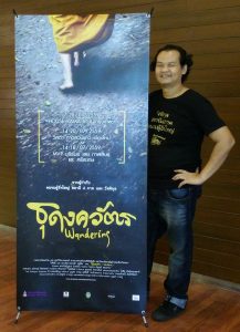 Director Boonsong Nakphoo with a standee poster for “The Wandering” premiere Saturday at House Rama, RCA. Photo: Boonsong Nakphoo / Courtesy