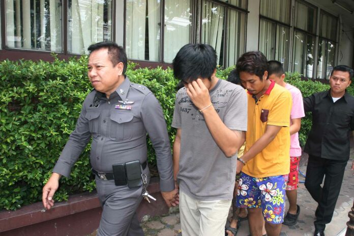 Several of the suspects are escorted May 3, 2016, by police to the criminal court.