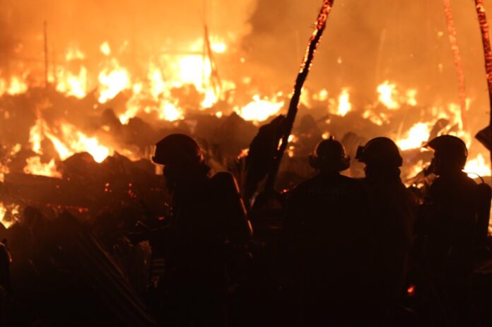 Fire strikes a workers camp in Bangkok’s Don Muang district Wednesday evening.