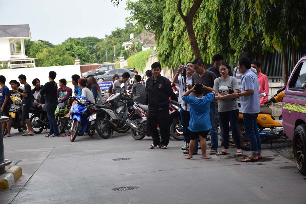 Friends of three teens killed during a police chase gathered in front of Phetkasem 2 Hospital on Sunday in Bangkok.