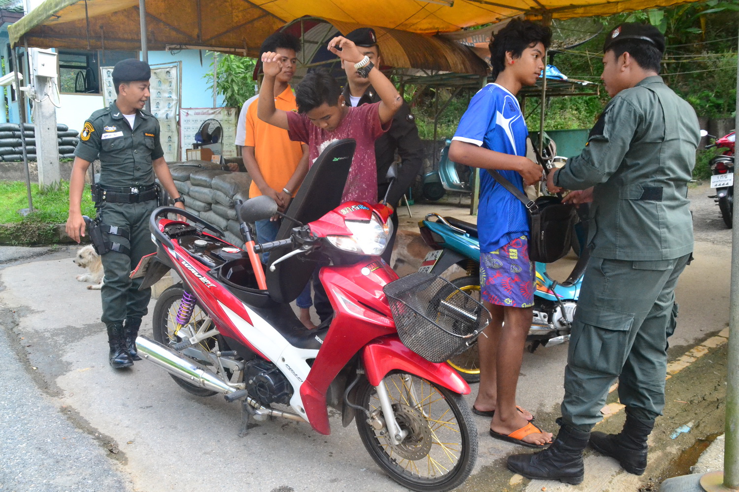Security officers stop and search travelers on July 15 at a roadside checkpoint in Yala province.
