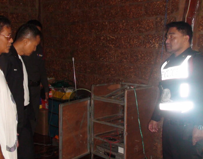Police inspect the crime scene at Wat Baan Non Khae on Wednesday morning.