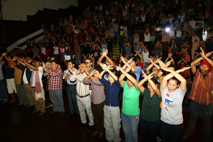 Opponents of the junta-backed constitution draft on Sunday do a 'Vote No' gesture at Thammasat University's Tha Prachan campus in Bangkok.
