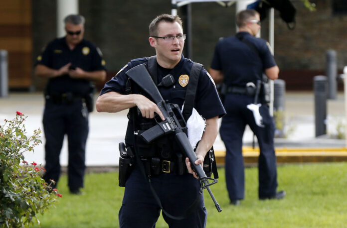 Police guard the emergency room entrance of Our Lady Of The Lake Medical Center, where wounded officers were brought, in Baton Rouge, La., on Sunday. Photo: Gerald Herbert / Associated Press