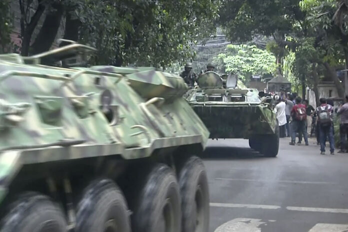 Armored vehicles arrive after militants took hostages at a restaurant popular with foreigners Saturday in Dhaka, Bangladesh. Photo: Associated Press