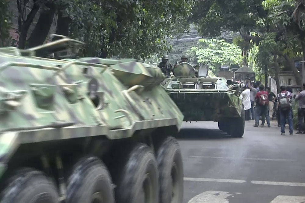 Armored vehicles arrive after militants took hostages at a restaurant popular with foreigners Saturday in Dhaka, Bangladesh. Photo: Associated Press
