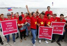 International Tribunal Finds No Historic Basis for Chinese Claims Behind ‘Nine-Dash Line’ Vietnamese expatriates cheer while displaying placards during a rally by the Manila's baywalk before the Hague-based U.N. international arbitration tribunal is to announce its ruling on South China Sea Tuesday, July 12, 2016, Philippines. Photo: Bullit Marquez / Associated Press