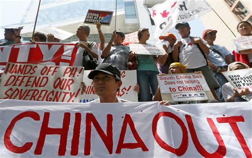 Protesters display their message during a rally outside of the Chinese Consulate hours before the Hague-based UN international arbitration tribunal is to announce its ruling on South China Sea Tuesday, July 12, 2016. Photo: Bullit Marquez / Associated Press