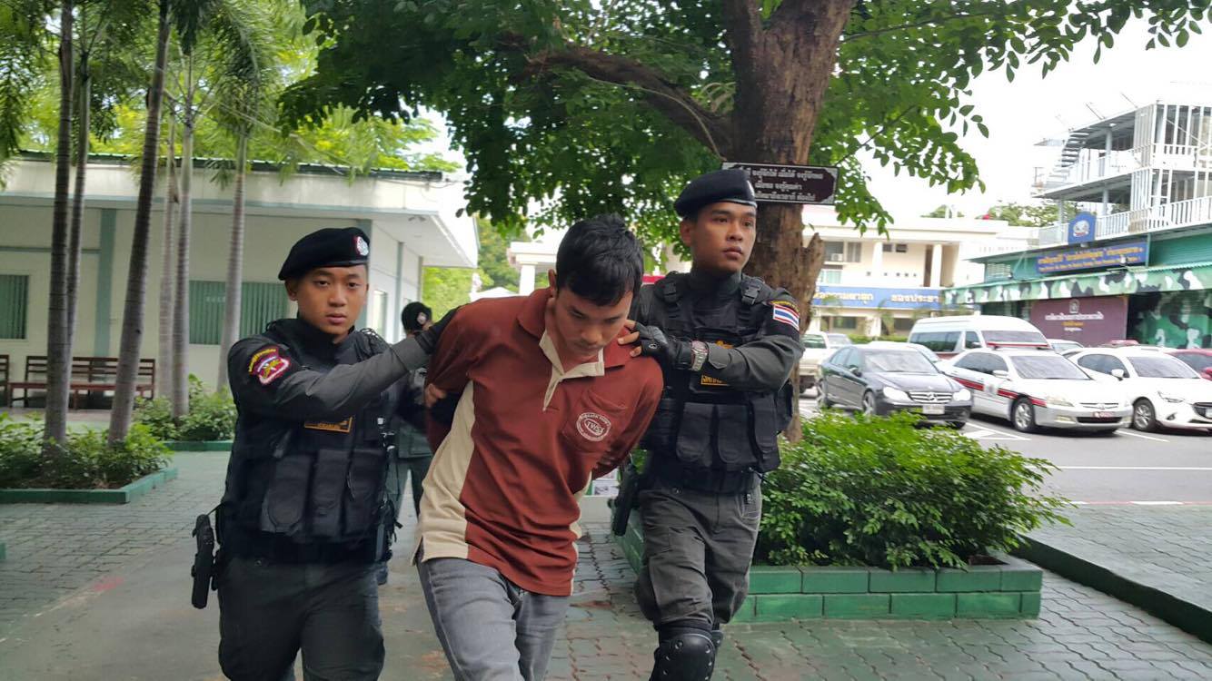 Chatree Ruamsungnoen, 27, is brought Monday to regional police headquarters in Bangkok where he confessed to killing a Saraburi province teacher.
