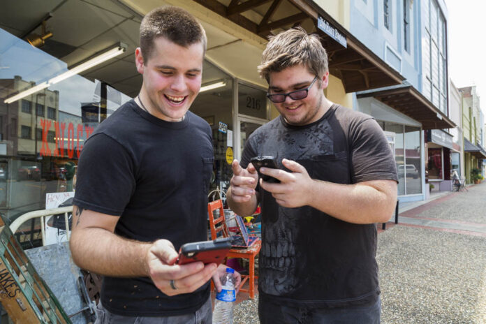 Brothers Jon and Ryan Edmonds play the augmented-reality smartphone game Pokemon Go in Texarkana, Arkansas on July 9. Photo: Joshua Boucher / Texarkana Gazette / Associated Press
