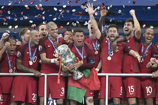 Portugal's Cristiano Ronaldo holds the trophy after winning the Euro 2016 final soccer match between Portugal and France at the Stade de France in Saint-Denis, north of Paris, Sunday, July 10, 2016. Photo: Martin Meissner / Associated Press