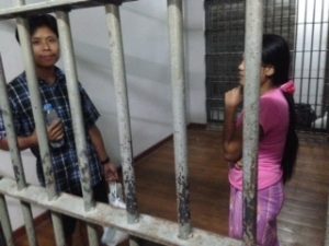 Burmese shrimp shed worker Tin Nyo Win, left, and his wife, Mi San, stand in a jail cell after they were arrested Nov. 13 in Samut Sakhon. Photo: Robin McDowell / Associated Press