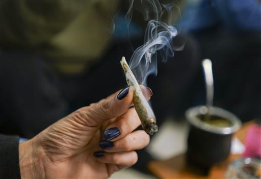 In this June 30, 2016 photo, a person smokes marijuana at the Asociacion de Estudios del Cannabis del Uruguay, in Montevideo, Uruguay. Photo: Matilde Campodonico / Associated Press