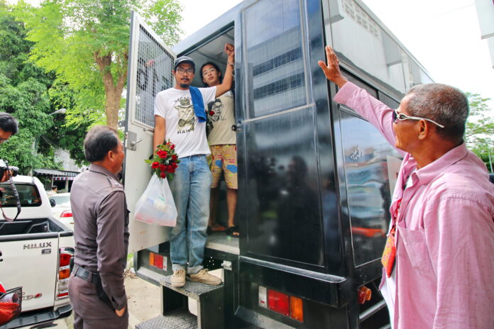 Taweesak Kerdpoka exits a police vehicle outside a Ratchaburi provincial courthouse on Monday.