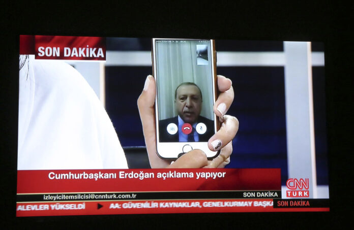 A live broadcast shows Turkish President Recep Tayyip Erdogan addressing the nation early Saturday from an undisclosed location via livestream from his smartphone. Photo: Depo / Associated Press