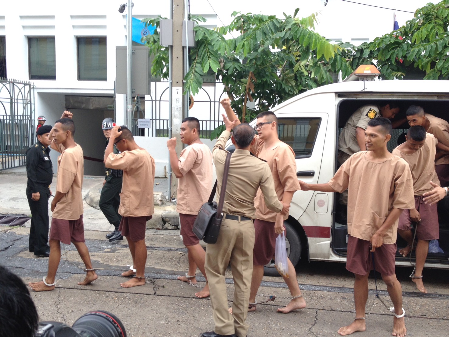 'Voting no is our right, it's not illegal!' activists opposed to the junta-backed charter referendum shout as they were brought to a military court Tuesday in Bangkok.