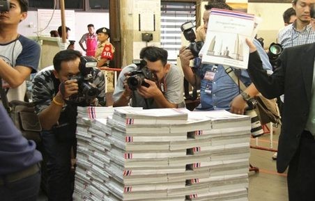 Copies of the draft constitution published by the Election Commission were displayed to the media Monday in Bangkok. Photo: Matichon